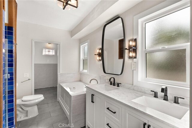 31955 10th Ave, Laguna Beach, CA 92651 - bathroom featuring a garden tub, double vanity, toilet, and tile patterned floors