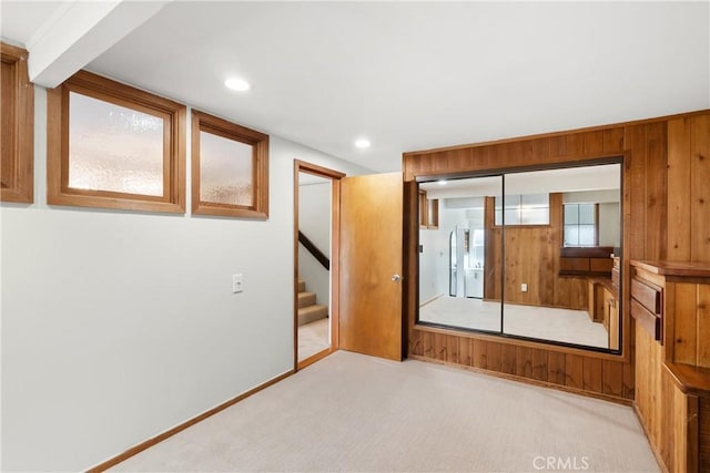 unfurnished bedroom with a closet and light carpet