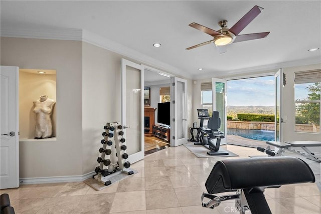 exercise area with crown molding, light tile patterned flooring, and ceiling fan