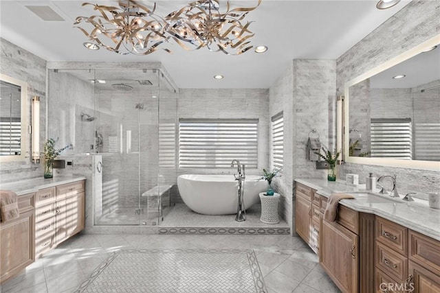 bathroom with vanity, shower with separate bathtub, and tile walls