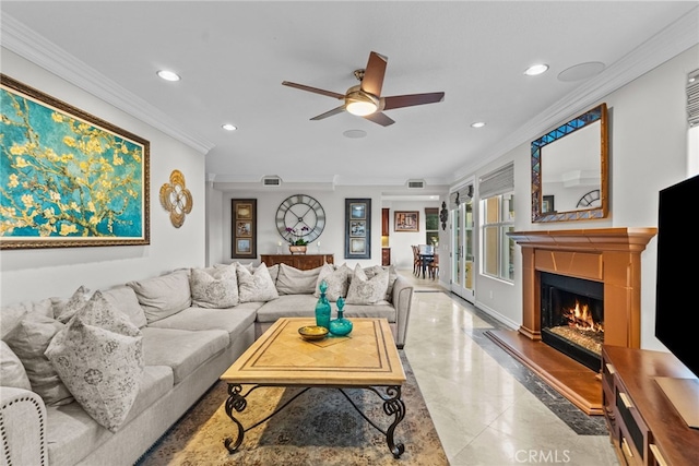 living room featuring ceiling fan, ornamental molding, and a fireplace