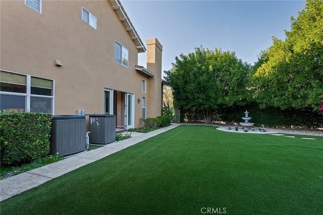 view of yard featuring central AC unit