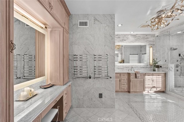 bathroom featuring vanity and tile walls