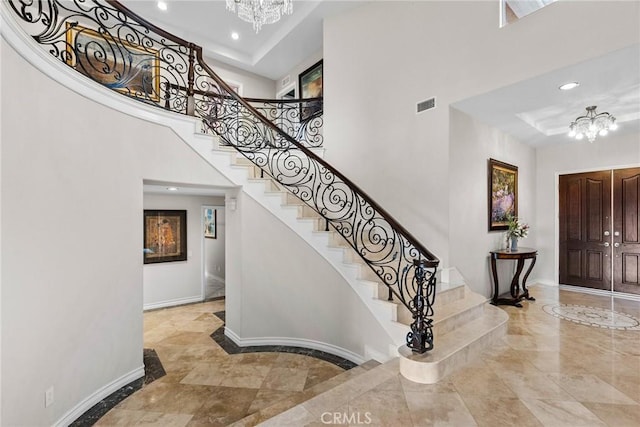 interior space with a chandelier and a high ceiling