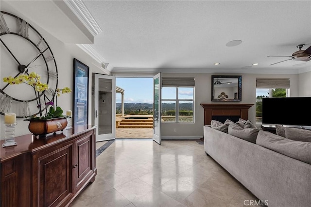 living room featuring crown molding and ceiling fan