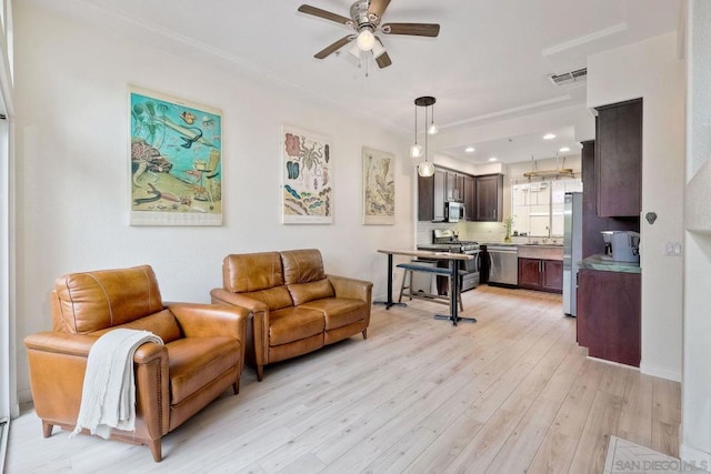 living room with ceiling fan and light wood-type flooring