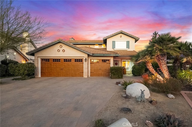 mediterranean / spanish-style house with a garage