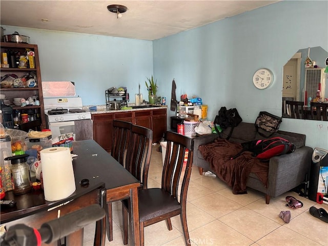 dining area featuring light tile patterned flooring and sink