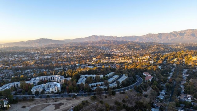 aerial view at dusk featuring a mountain view