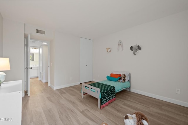 unfurnished bedroom featuring a closet and light hardwood / wood-style flooring