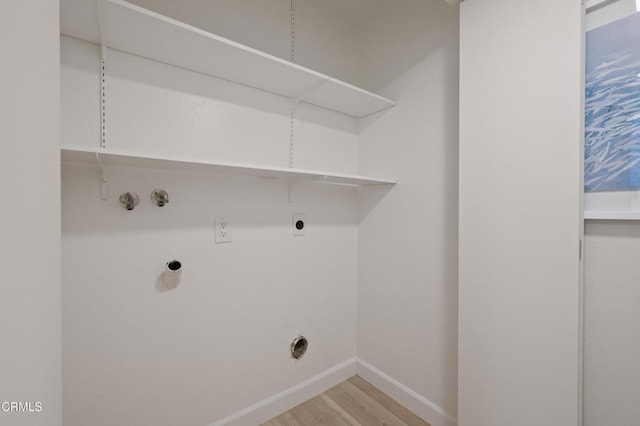 laundry room with hookup for a gas dryer, hookup for a washing machine, hookup for an electric dryer, and light wood-type flooring