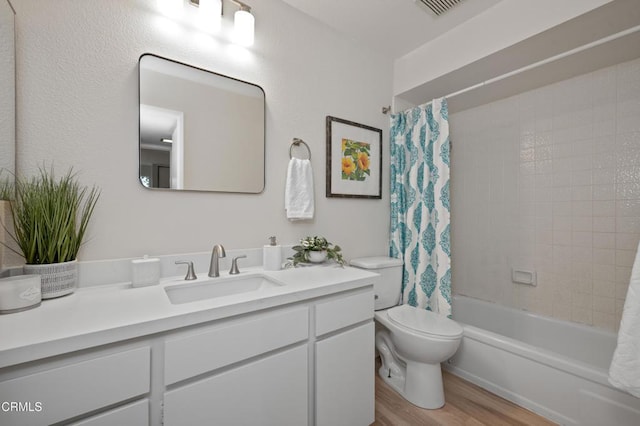 full bathroom with wood-type flooring, toilet, shower / tub combo, and vanity