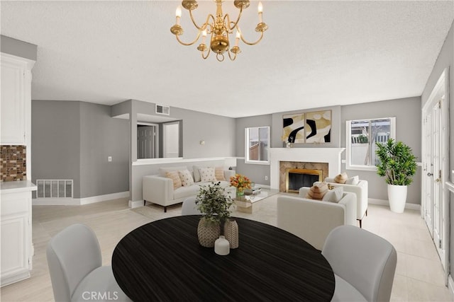 dining room with visible vents, baseboards, and a premium fireplace