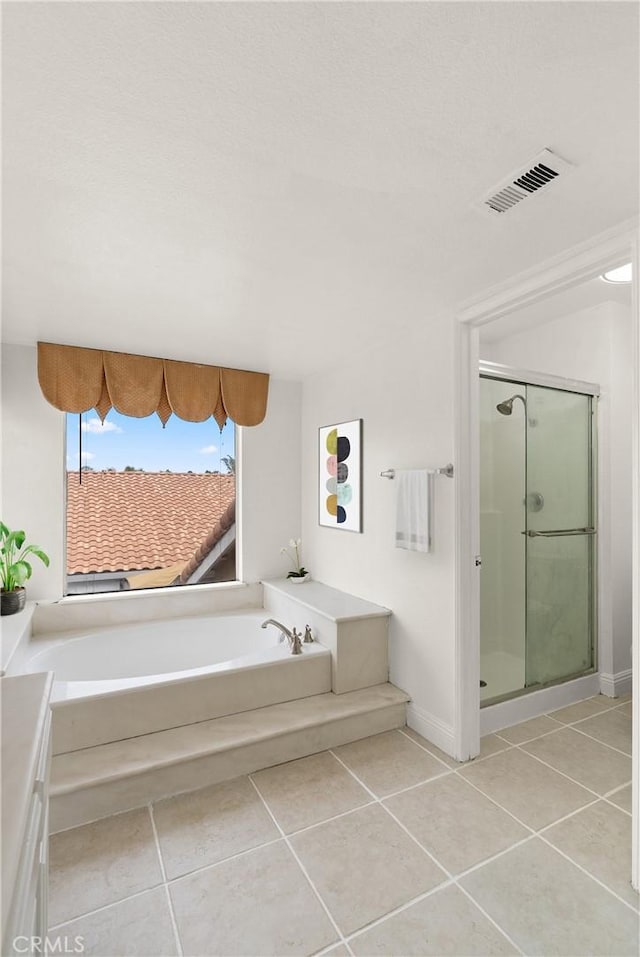 full bath featuring a shower stall, a bath, visible vents, and tile patterned floors