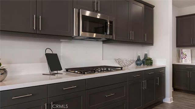 kitchen featuring stainless steel appliances and dark hardwood / wood-style flooring