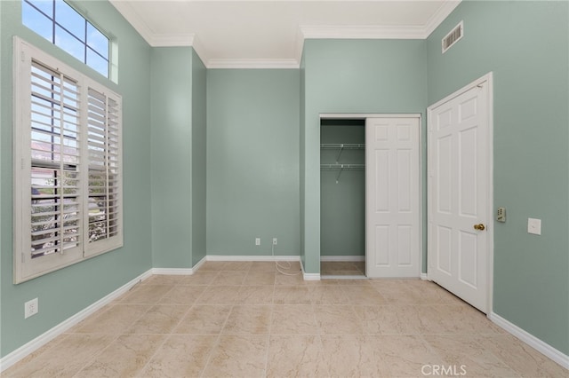 unfurnished bedroom featuring ornamental molding, a closet, and light tile patterned flooring