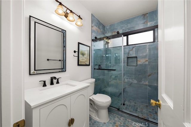 bathroom featuring walk in shower, vanity, and toilet