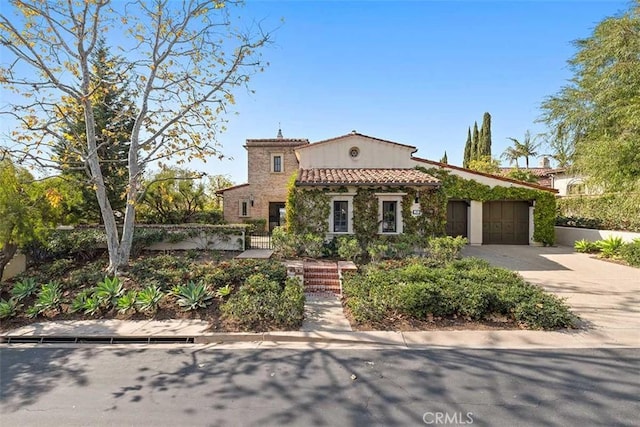 mediterranean / spanish-style home featuring a garage