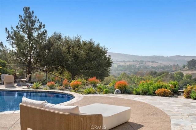 view of pool with a mountain view and a patio area