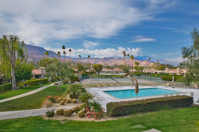 view of pool featuring a mountain view and a lawn