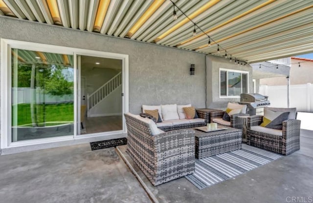 view of patio with area for grilling and outdoor lounge area