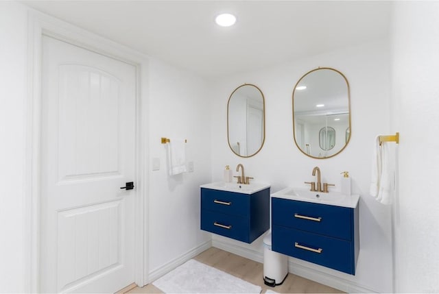 bathroom with hardwood / wood-style flooring and vanity