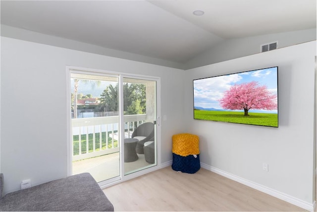 bedroom with vaulted ceiling and light wood-type flooring