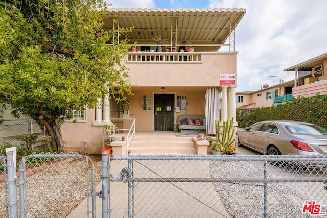 view of front of property with a balcony