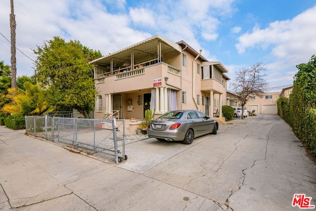 view of front of house with a balcony