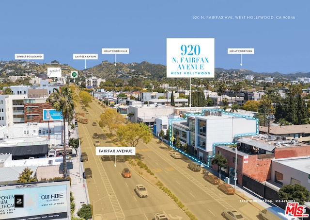 birds eye view of property with a mountain view