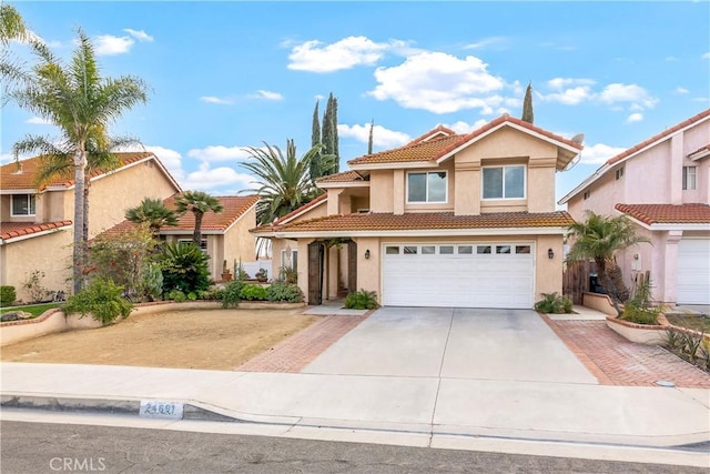 mediterranean / spanish-style home with a garage