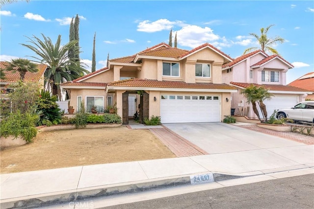 mediterranean / spanish-style house with a garage