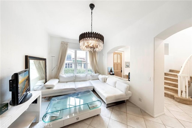 tiled living room featuring an inviting chandelier