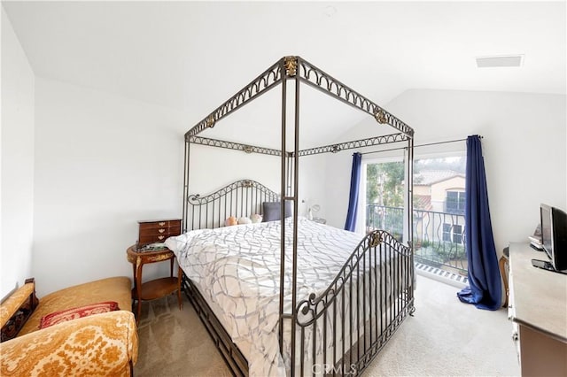 bedroom with lofted ceiling, access to exterior, and carpet