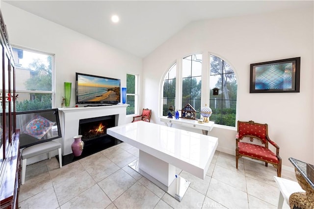 living area with lofted ceiling, light tile patterned floors, and plenty of natural light