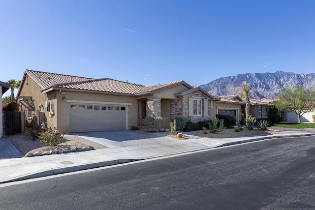 view of front of property with a garage and a mountain view