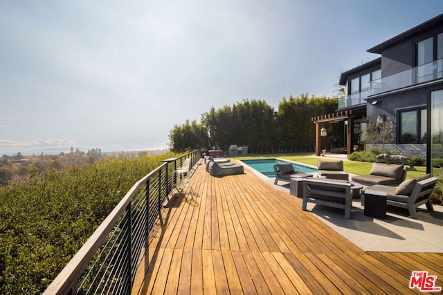 deck with an outdoor living space and a pergola