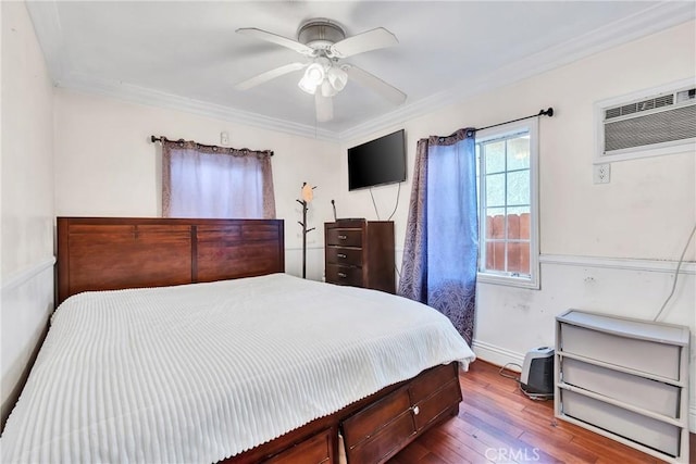 bedroom with wood-type flooring, an AC wall unit, ornamental molding, and ceiling fan