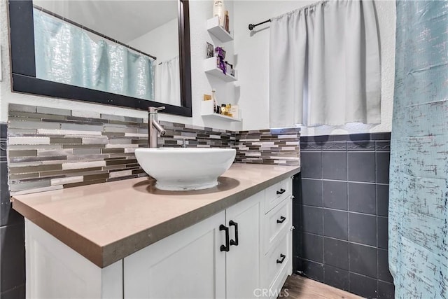 bathroom with vanity and tile walls