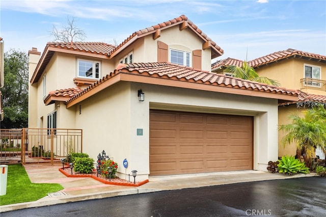 mediterranean / spanish-style home with a garage