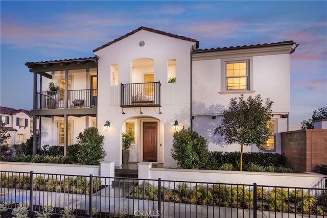 mediterranean / spanish home featuring a balcony