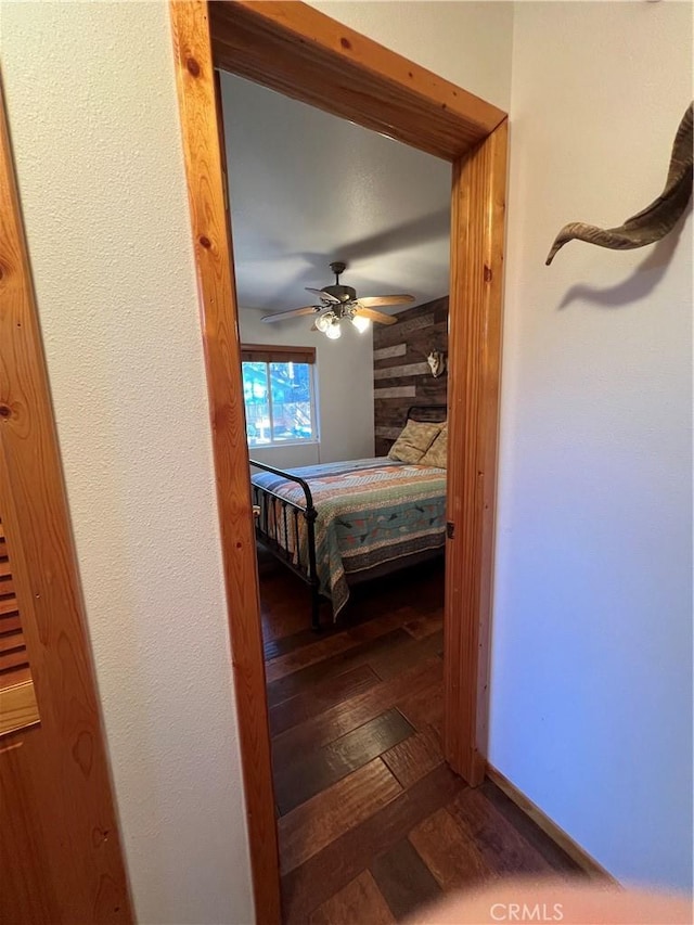 unfurnished bedroom featuring ceiling fan and dark hardwood / wood-style flooring