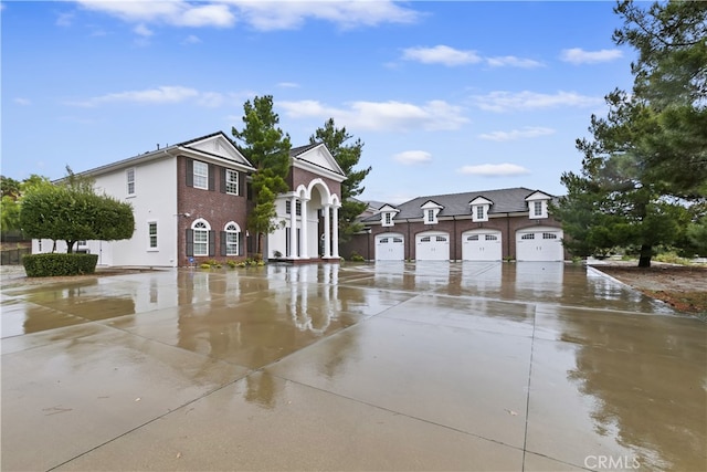 view of front of home with a garage, a residential view, and brick siding