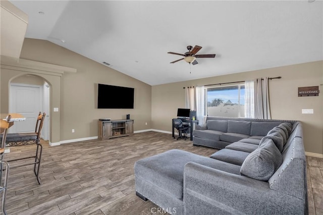 living room with lofted ceiling, hardwood / wood-style floors, and ceiling fan