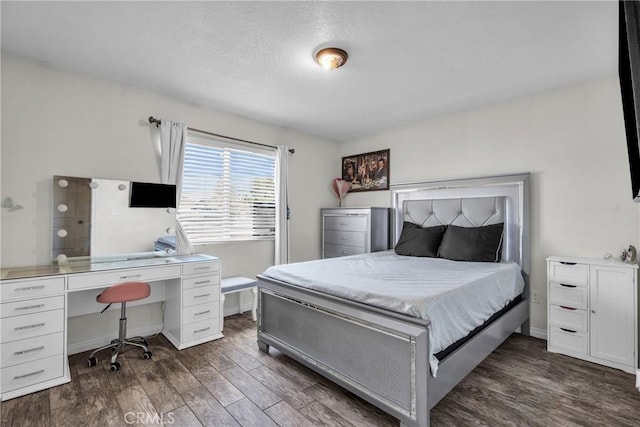 bedroom with dark hardwood / wood-style floors