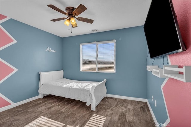 bedroom with dark hardwood / wood-style floors and ceiling fan