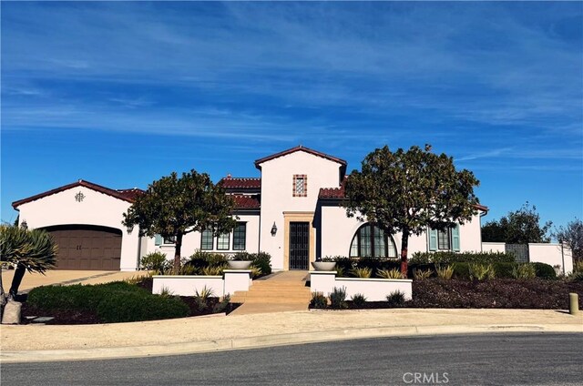 mediterranean / spanish-style house with a garage