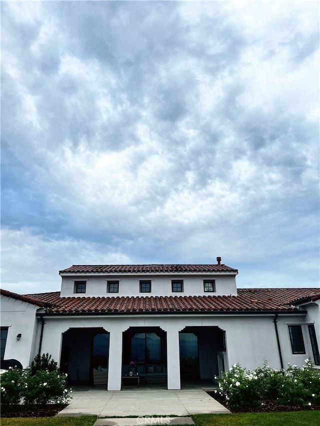 back of house featuring a yard and a patio