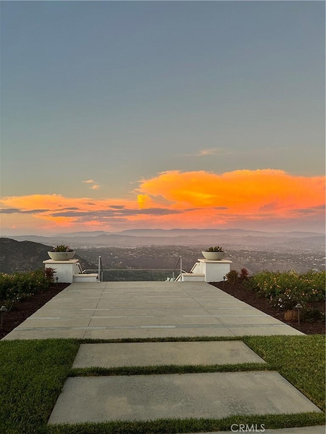 patio terrace at dusk with a mountain view