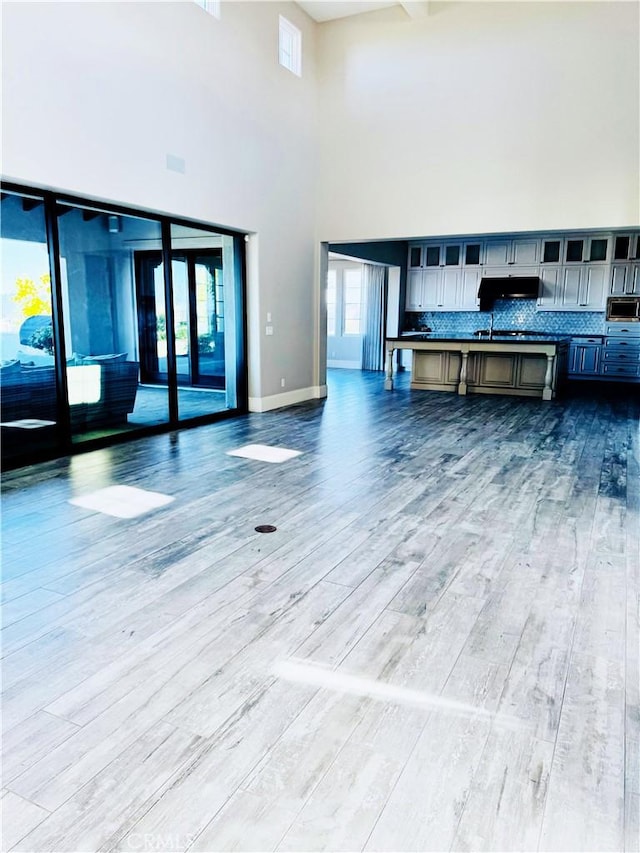 unfurnished living room with wood-type flooring and plenty of natural light